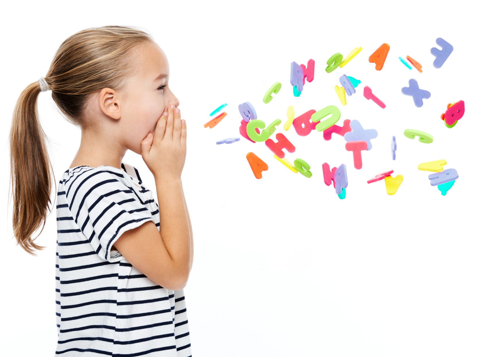 Girl blowing colorful alphabet letters.